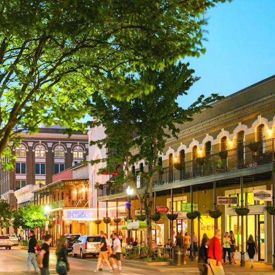 Historic downtown Palafox Street at dusk with shops and balconies